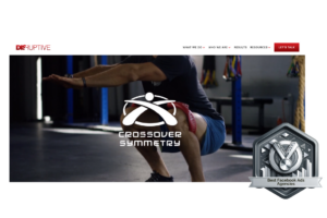 Silver award badge from Best Facebook Ads Agencies 2024 placed on the Disruptive Advertising homepage, beside an image of a person demonstrating a Crossover Symmetry exercise, symbolizing a blend of physical strength and strong marketing prowess