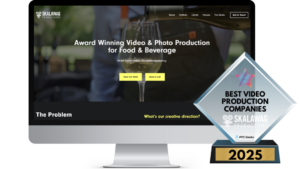 A computer screen displaying Skawlag Productions' homepage with an image of a wine glass being poured, alongside a Best Video Production Companies 2025 award in the foreground.