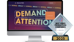 A computer screen showing Beacons Point's vibrant homepage with bold text saying “Demand Attention” and a Best Video Production Companies 2025 award in the foreground.