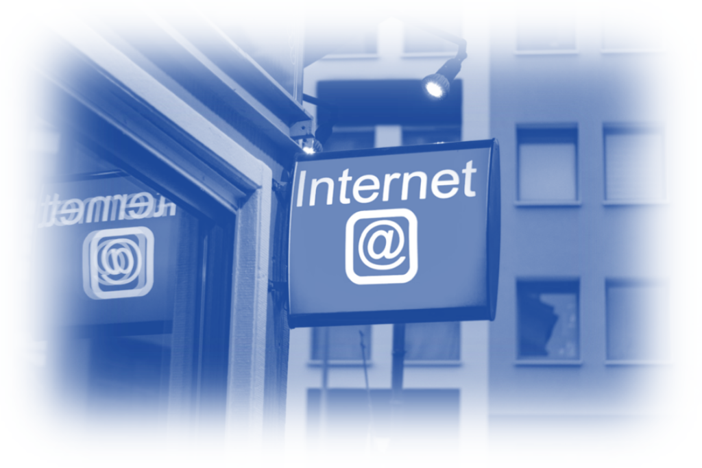 A blue-toned image showcasing an urban street scene with a prominent sign labeled "Internet" featuring an at symbol. The sign is attached to a building and lit by a spotlight, symbolizing the evolving digital landscape in a cookieless future.