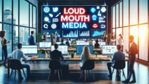 A vibrant office with a team of professionals working on digital marketing campaigns. A prominent sign reading "Loud Mouth Media" is displayed in the background. The office features modern technology, including large screens showing analytics and PPC campaign dashboards.